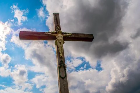 Crucifix. On the background of the cloudy sky. Stock Photos