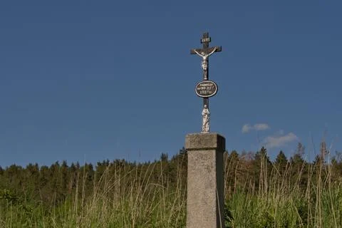 Crucifix standing by the wayside in the fields Stock Photos