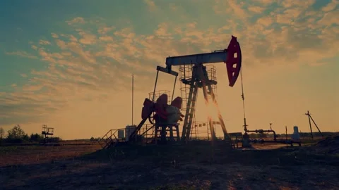 Crude pump jack working on sunrise in oil field. Oil Pump Jack Stock Footage 321061498