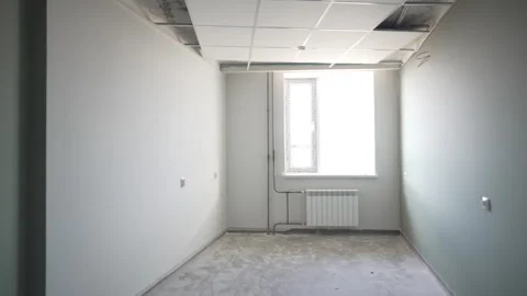 Crude room with windows offering view of construction zone Stock Footage 311386842