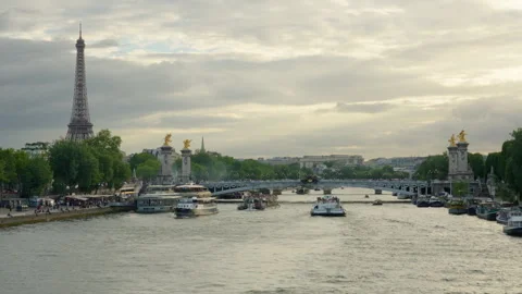 Cruise boats navigate the Seine River near the Eiffel Tower in Paris France Stock-Footage 337242530