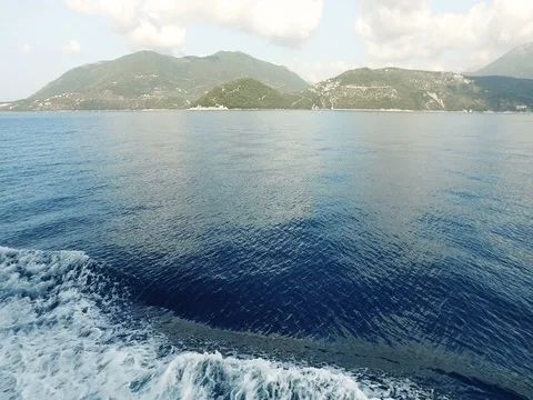 Cruise ship and it's engine propellers churn the water into waves, Ionian Sea Stock Footage 80053391