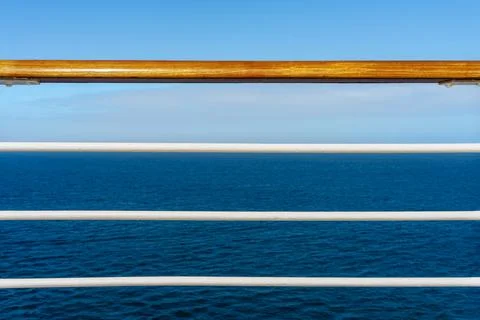 Cruise ship deck railing and a ocean view with blue sky Stock Photos