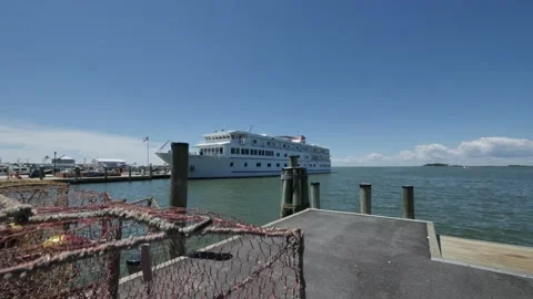 Cruise Ship at Dock, tilt down to colorful crab trap Stock Footage 199804115