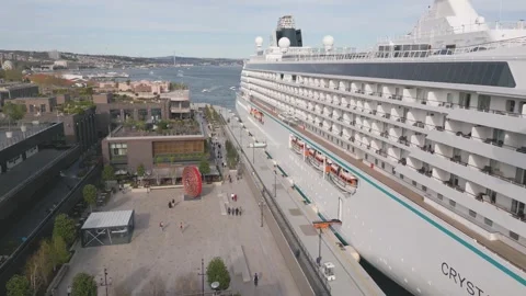 Cruise ship docking at waterfront location during sunny day Stock Footage 310153264