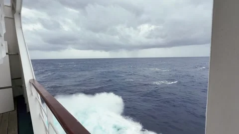 Cruise ship mid-ship looking out towards rain storm on horizon Stock Footage 332228271