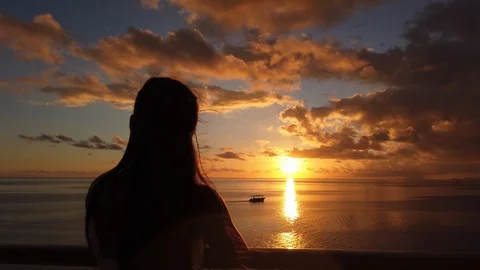 Cruise ship passenger watching sunset over the sea enjoying travel vacation Stock Footage