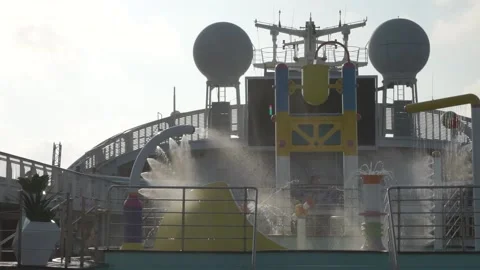 Cruise ship sailing through ocean with kids enjoying the pool. Video stock 135449750