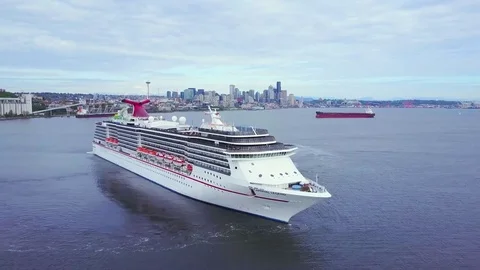 Cruise ship in the sea against city buildings Stock Footage