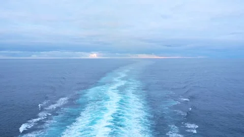 Cruise Ship Sunset Wake on Calm Open Ocean Waters. Blue Sea Cloudy Sky Natu.. Stock Footage 314413787