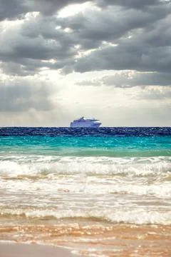 Cruise ship under dramatic sun clouds mix on the sea of atlantic ocean Stock Photos