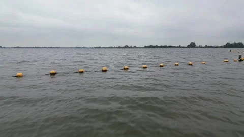 Cruising over the sandy shore by the side of Surfplas manmade lake in Holland Stock Footage 260602714
