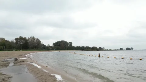 Cruising over the sandy shore by the side of Surfplas manmade lake in Holland Stock Footage 260602780