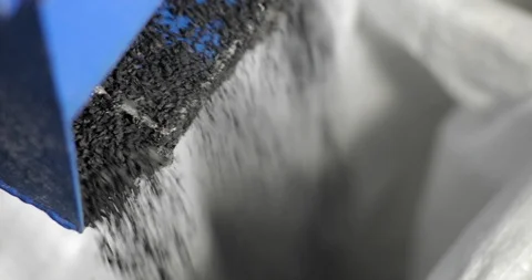 Crumb rubber granulate obtained on processing plant falling from machine. Stock Footage 129902219