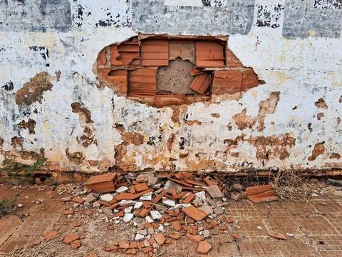 Crumbled brick wall exposing layers Stock Photos