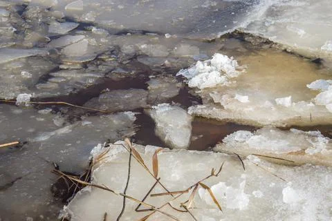 Crumbled ice on a river in spring on a cold sunny day close up. Stock Photos