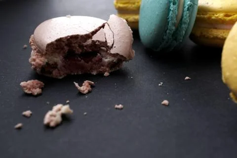Crumbled macaroons on stylish dark background Stock Photos