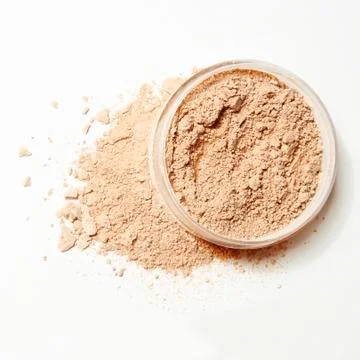Crumbled natural powder with package on white background Stock Photos