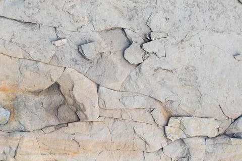 Crumbled white stone, with traces of rust. Stock Photos