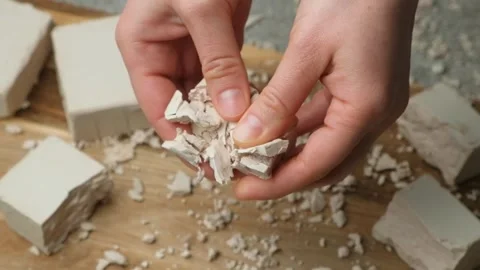 Crumbling moist yeast block by hands slow motion Stock Footage 310250858