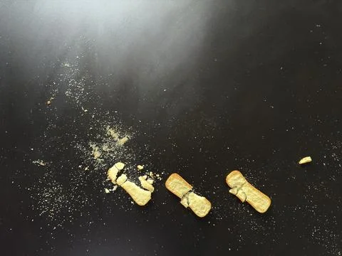 Crumbs on Dark Table Stock Photos