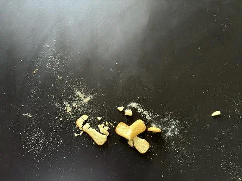Crumbs on Dark Table Stock Photos