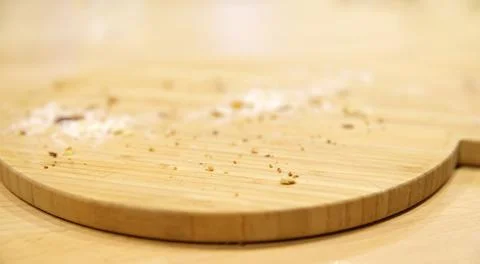 Crumbs from freshly baked bread on an empty wooden board Stock Photos
