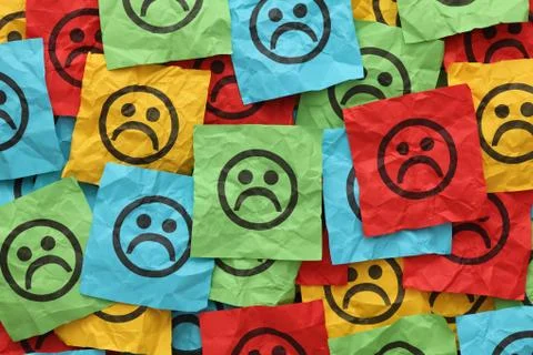 Crumpled adhesive notes with sad faces Stock Photos