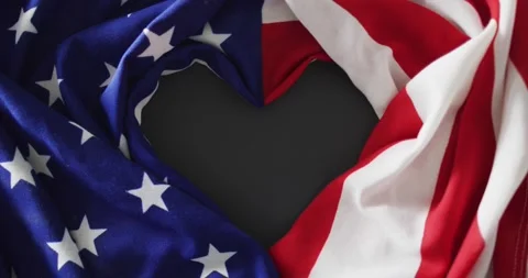Crumpled american flag with heart shape and stars and stripes lying on gray Stock Footage 337159017