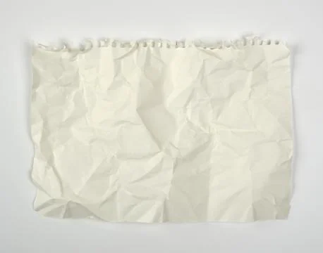 Crumpled blank white rectangular sheet of paper torn out of a spiral notebook Stock Photos