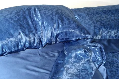Crumpled blue bed Stock Photos