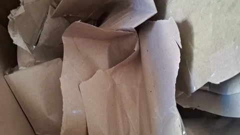 Crumpled brown paper packing material inside a cardboard shipping video footage Stock Footage 337897019