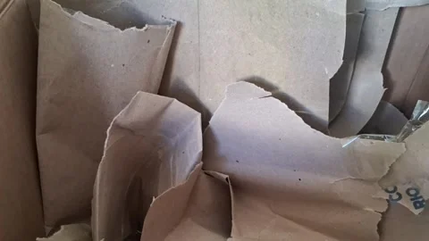 Crumpled brown paper sheets shifting inside a cardboard box video motion Stock Footage 337896984