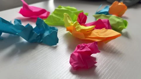 Crumpled Colorful Sticky Notes on Table Stress and Failed Ideas Concept Stock Footage 337123311
