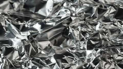 Crumpled foil close-up. Macro shooting of mashed metal paper. Silver background Stock Footage 168557017