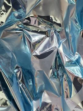 Crumpled foil texture abstract background for Easter packaging and festive desig 写真素材