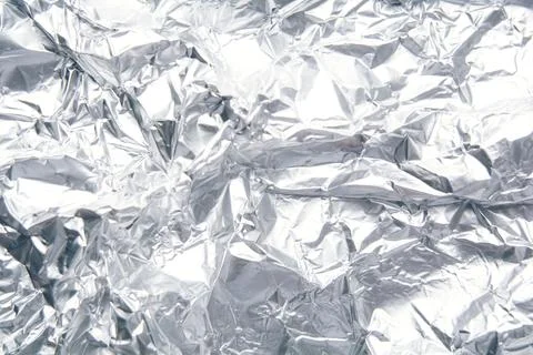 Crumpled foil texture background, silver shiny material Stock Photos