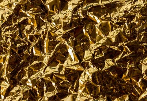 Crumpled gold foil texture background Stock Photos