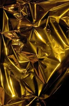 Crumpled gold surface. Stock Photos