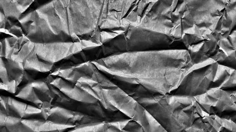 Crumpled grey paper texture creating dark dramatic shadow in organic minima.. 写真素材