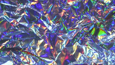 Crumpled Holographic Foil Texture Background in Shimmering Stop Motion Animation Stock Footage 311501551