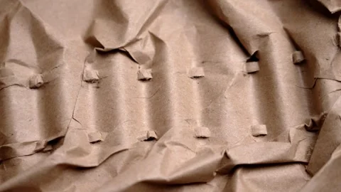 Crumpled kraft packaging paper with many folds Stock Footage 329097667