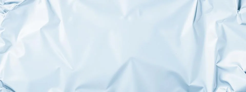 Crumpled light blue foil texture background, smooth metallic surface, soft .. Stock Illustration