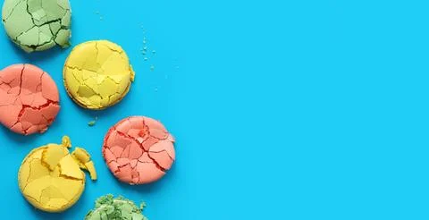 Crumpled macarons, flat lay. Broken macaron on blue background Fotos Stock