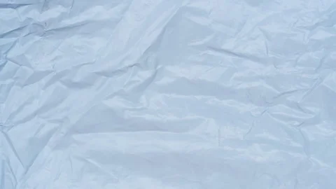 Crumpled Pale Blue Paper Surface Shifts in a Seamless Loop, Creating a Clean Min Stock Footage 340609856
