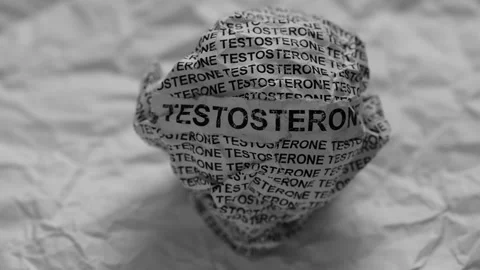 Crumpled paper ball with words Testosterone on crumpled white paper background. Stock Footage 310093536