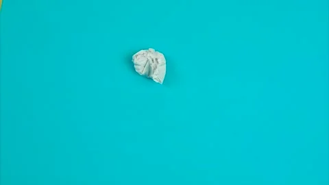 Crumpled paper on a blue background, stop-motion animation Stock Footage 136848610