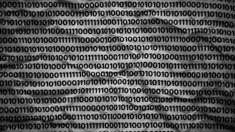 A crumpled paper covered with rows of repeating binary code Photos
