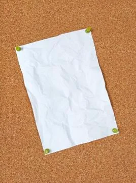 Crumpled paper pinned to corkboard Stock Photos