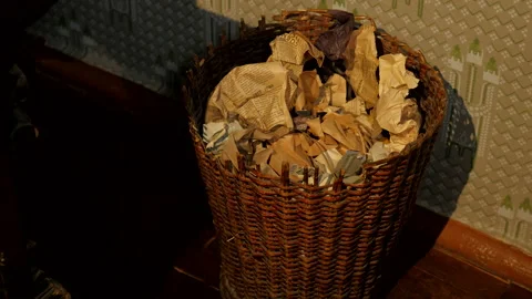 Crumpled papers being thrown into twisted wooden waste basket Video stock 161481535